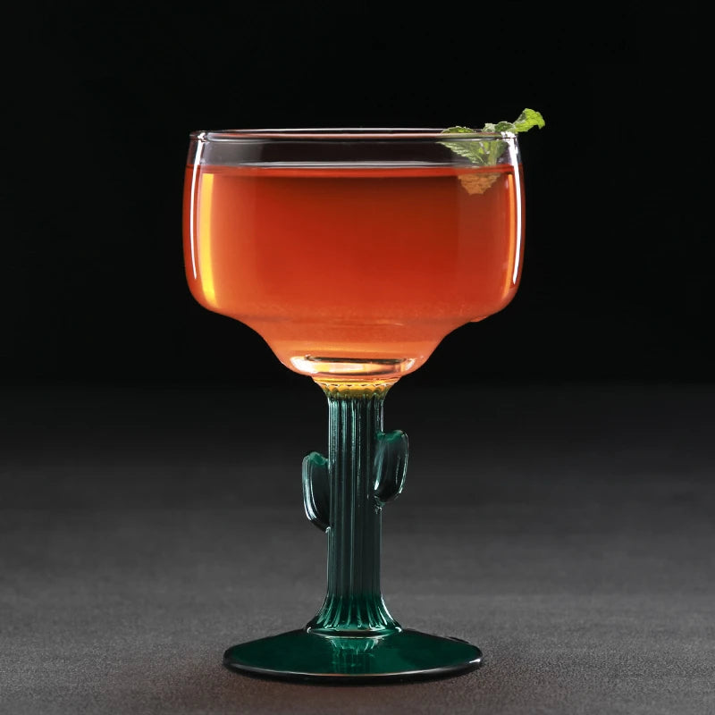 Cocktail in a cactus-shaped glass with a dark background