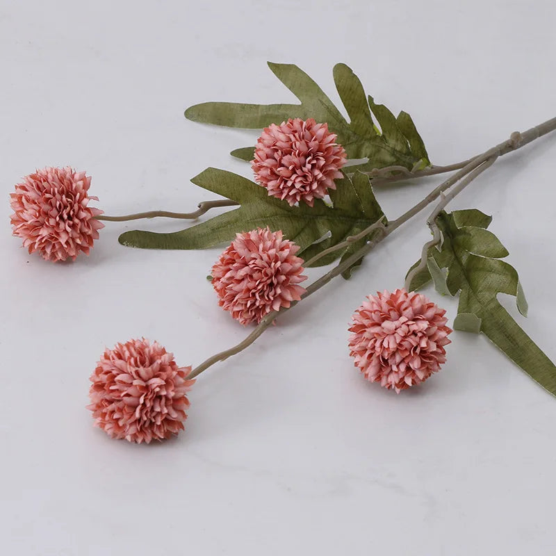Fuzzy pink flowers on a stem.