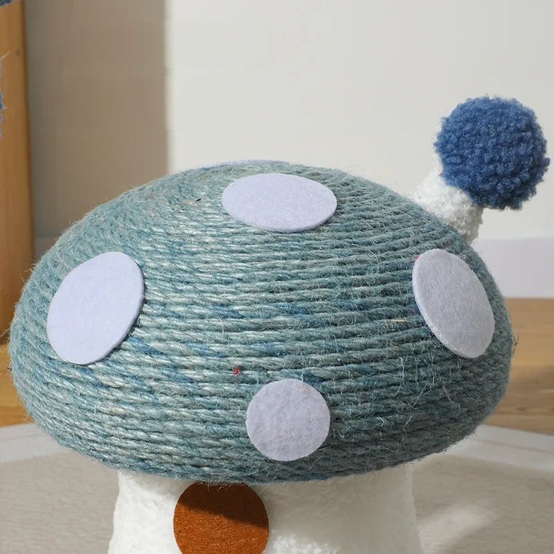 Toy mushroom with teal cap and white spots on a wooden surface