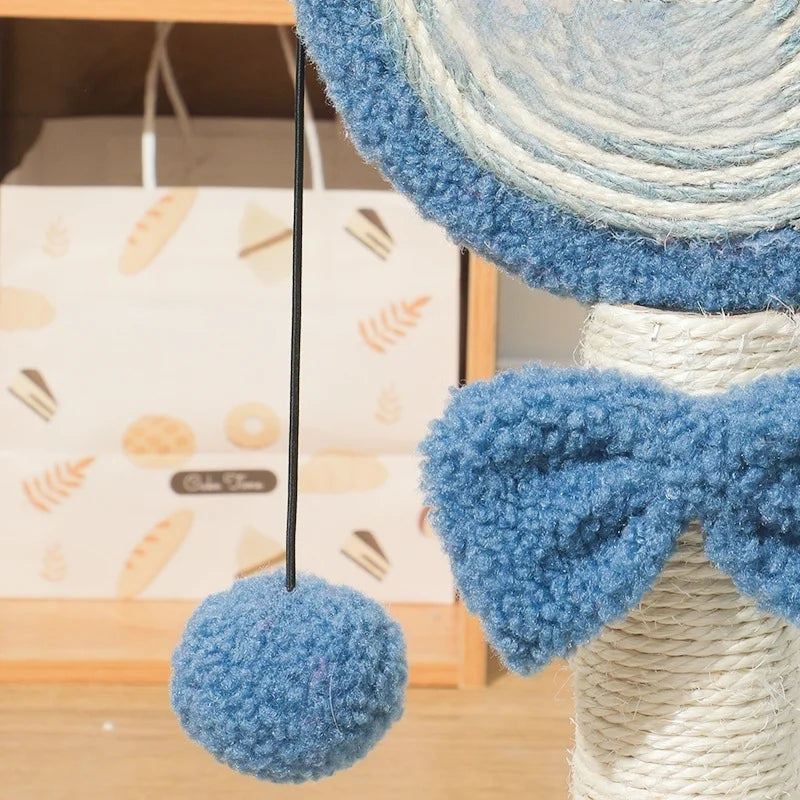 Blue textured ball hanging from a woven cat tree with a blurred background