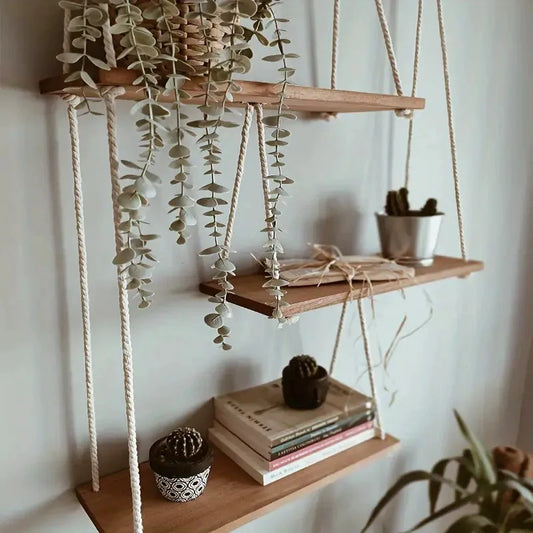 Decorative boho hanging shelf for plants and home decor accents.