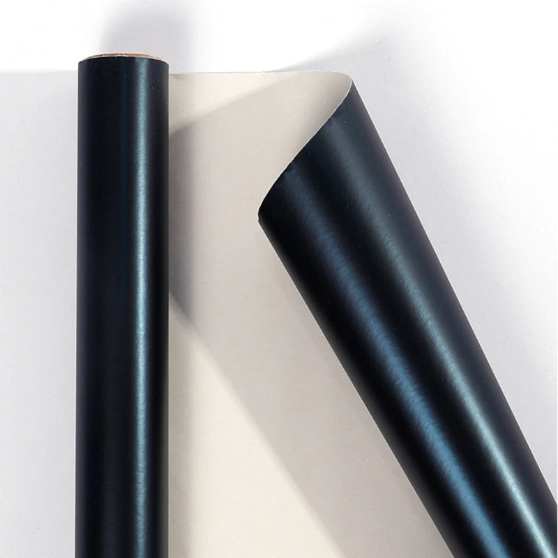 Two rolls of black vinyl wrap on a white background