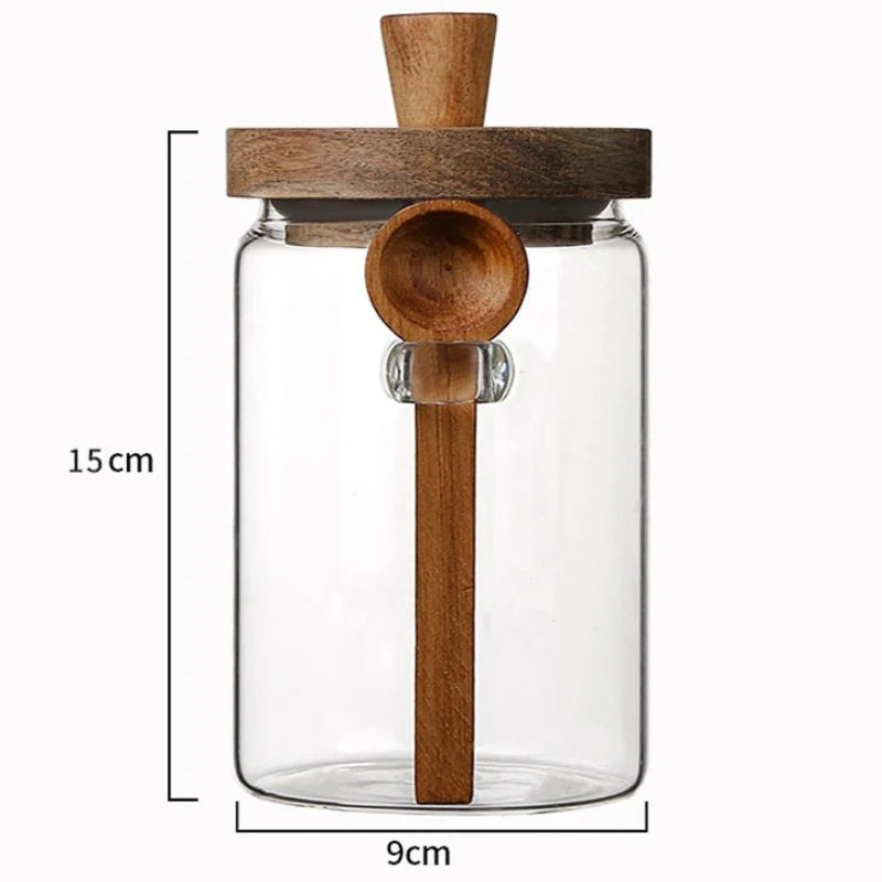 Clear glass jar with wooden spoon and lid, featuring dimensions on a white background