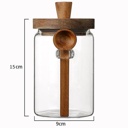 Clear glass jar with wooden spoon and lid, featuring dimensions on a white background