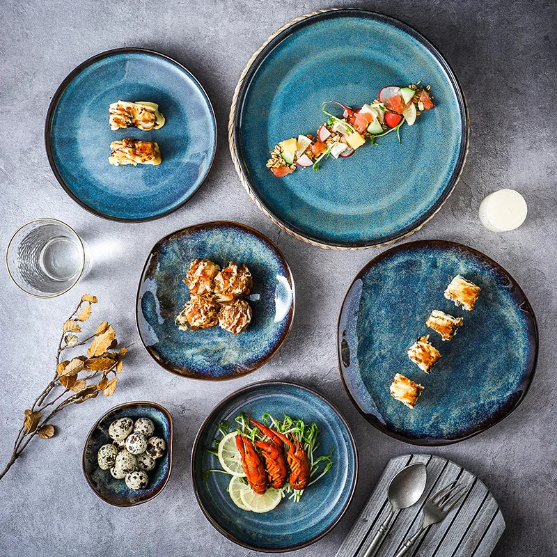 Assorted dishes on blue ceramic plates with a gray background