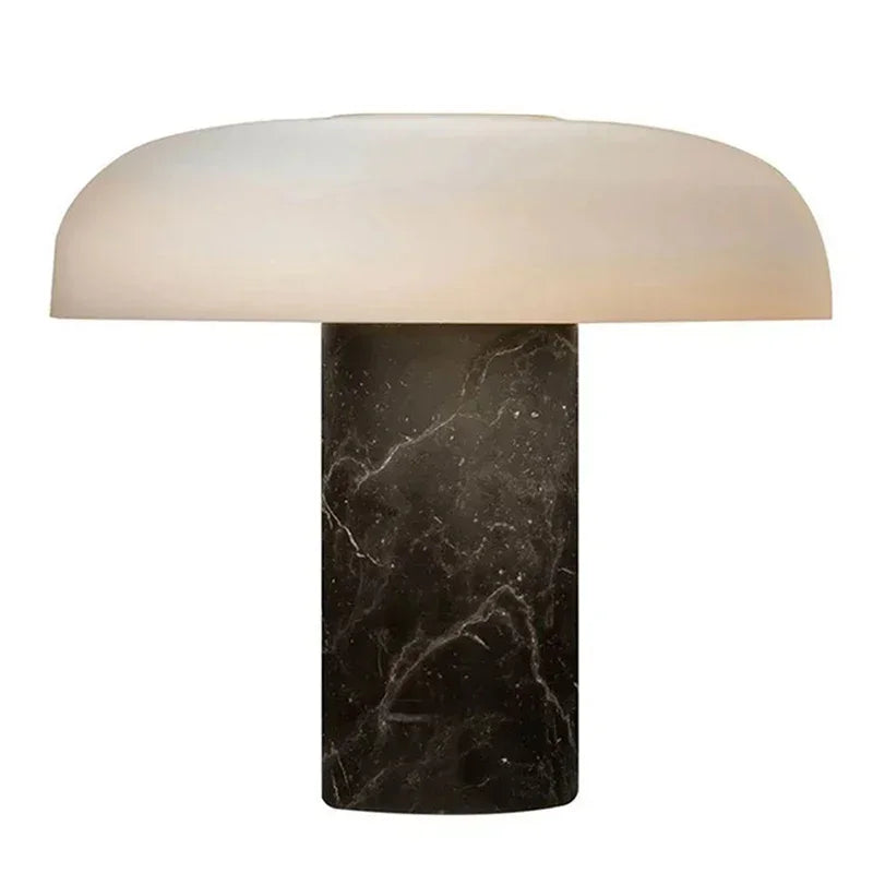 A modern mushroom-shaped table lamp with a dark marble base and a white dome shade, isolated on a white background.