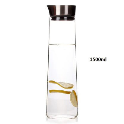 A glass carafe with a metal lid, filled with water and lemon slices, showing its 1500ml volume.