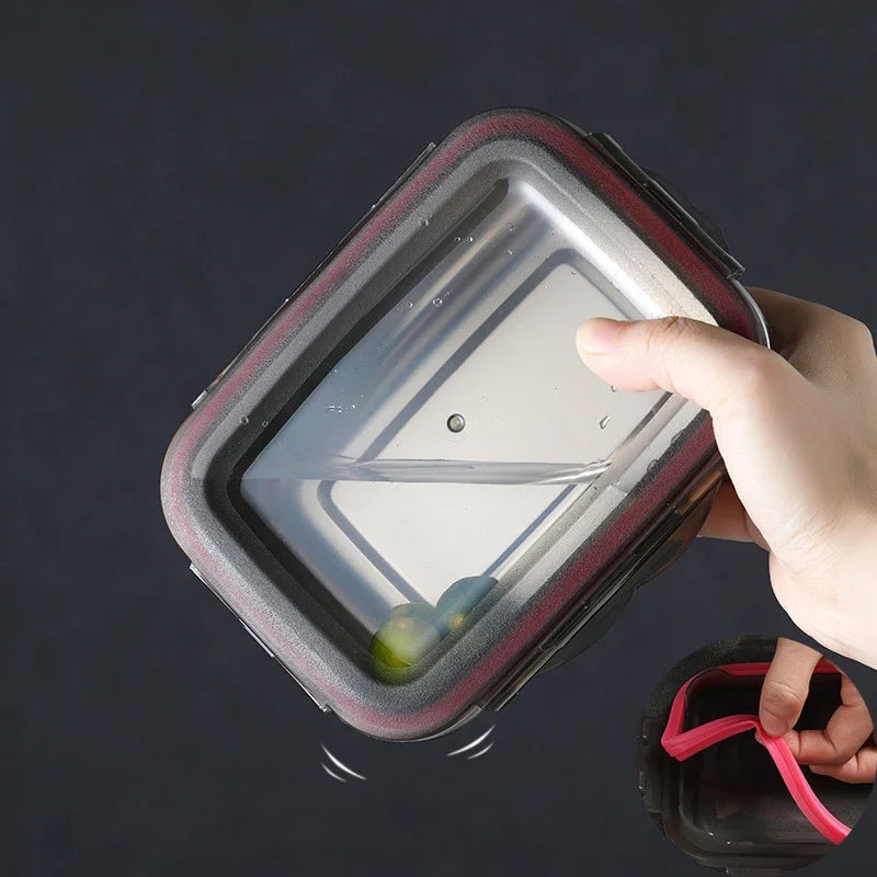 A hand holds a clear food container upside down, demonstrating its leak-proof seal.