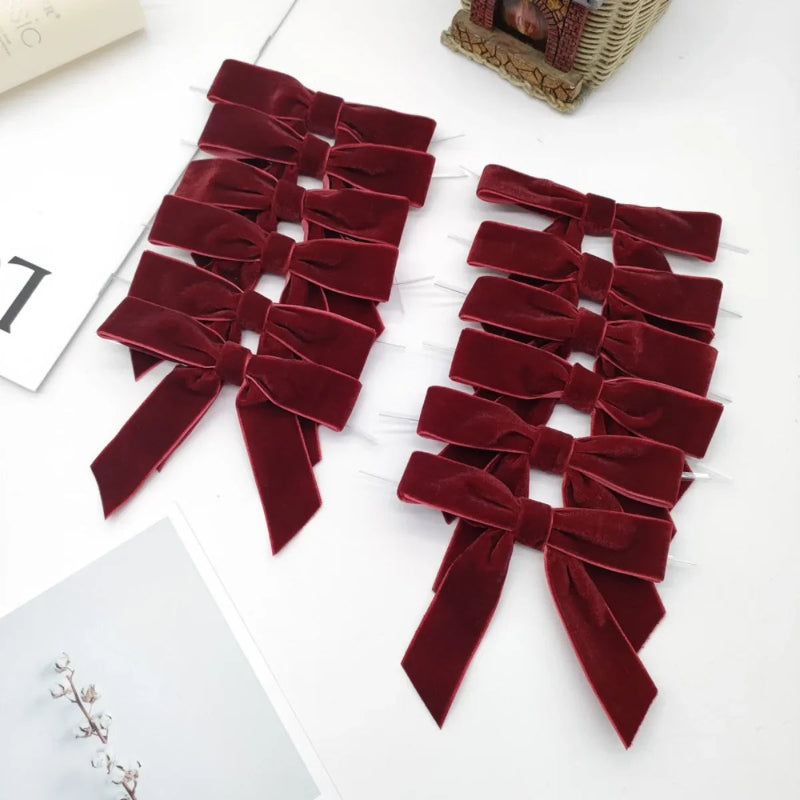 Set of red velvet bows on a white surface