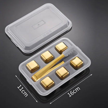 Set of gold-colored cubes and a tool in a clear plastic container with dimensions indicated.