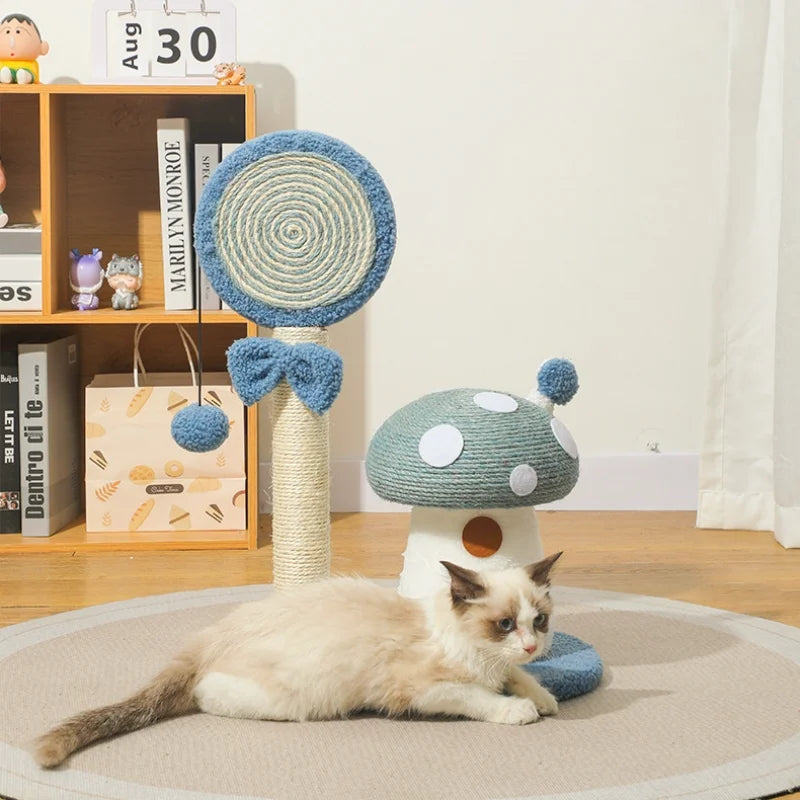 Cat lying on a round mat next to a mushroom-shaped cat toy with a shelf in the background.