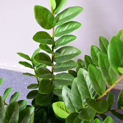 Close-up of artificial Ficus branches with vibrant green leaves.