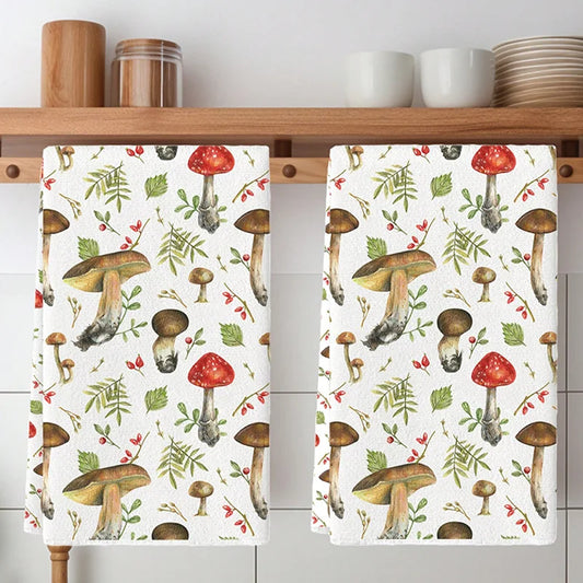 Two kitchen towels with mushroom pattern hanging on a wooden rack.