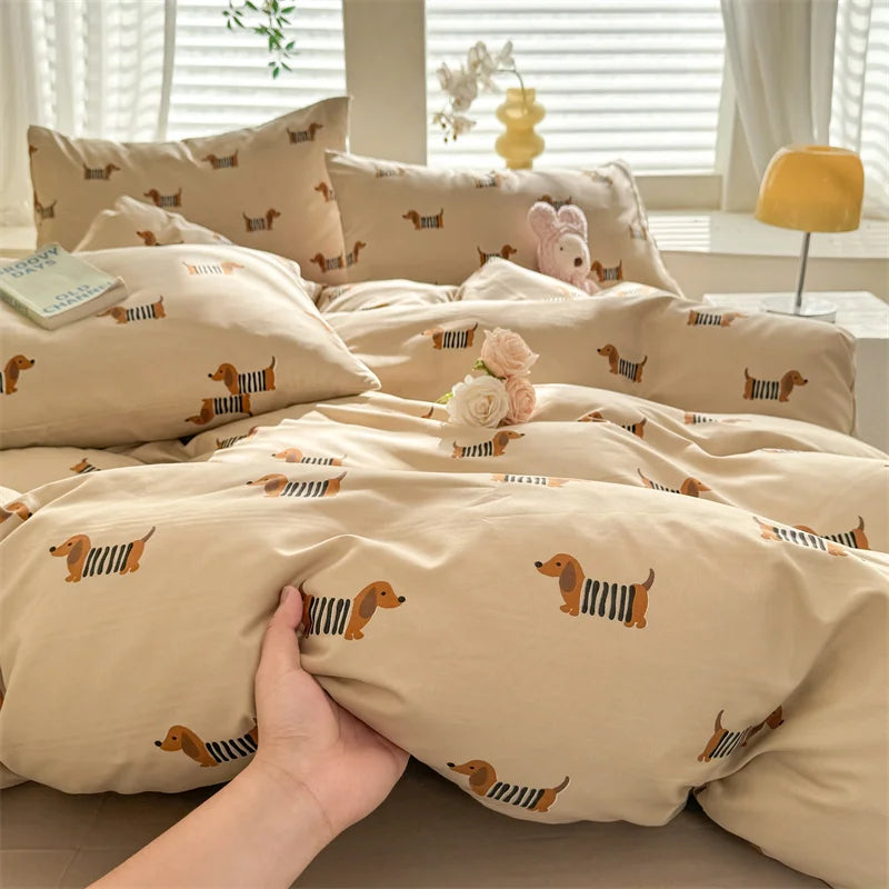 Beige bedding set with dog pattern on a bed in a bright room.