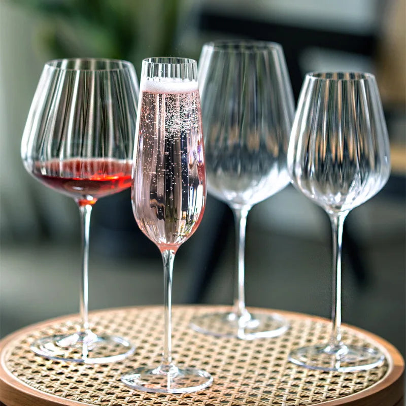 Four fluted glasses, two with drinks.