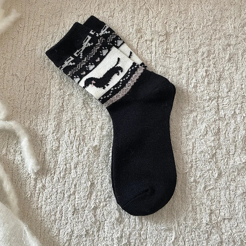 Black sock with white pattern on a textured beige surface