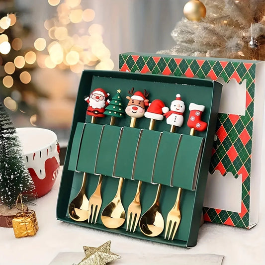 Set of gold Christmas-themed spoons in a decorative box with a festive background.