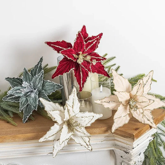 Decorative poinsettias and candles on a wooden surface with a white background