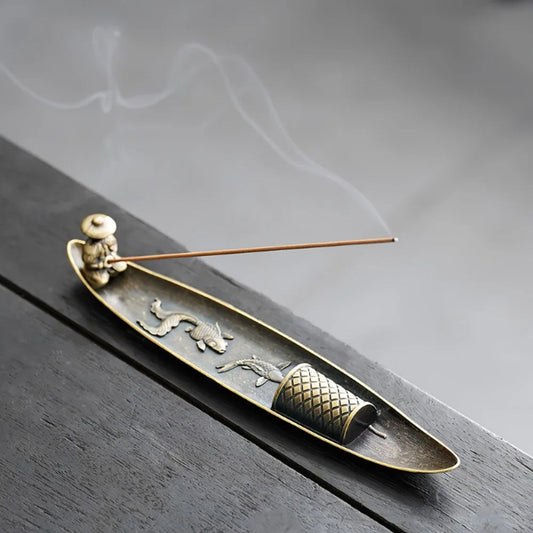 Decorative incense holder with incense on a wooden surface