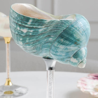 Decorative shell with a marble pattern on a stand against a neutral background