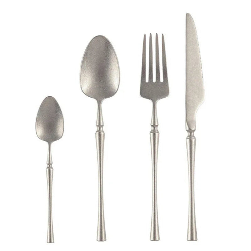 Set of silver cutlery including a tea spoon, dinner spoon, dinner fork, and dinner knife on a white background.