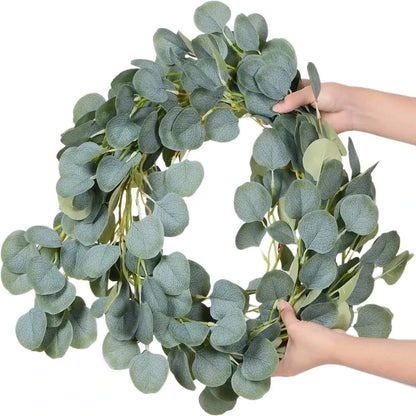 Artificial eucalyptus garland shaped into a wreath, showcasing its versatile design and lifelike leaves, perfect for door decor or as a centerpiece for seasonal celebrations.