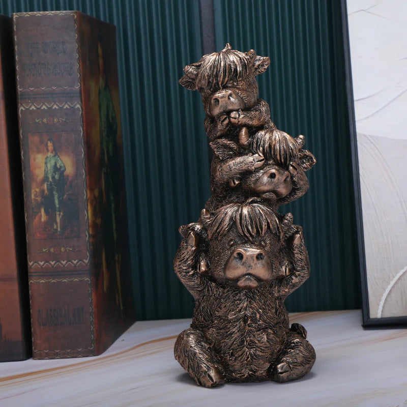 Bronze sculpture of a bear with cubs on a marble surface