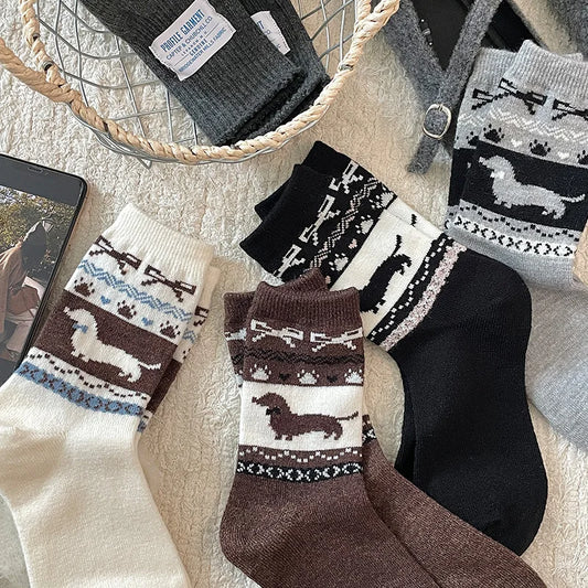 Collection of patterned socks with dachshund design on a textured surface.