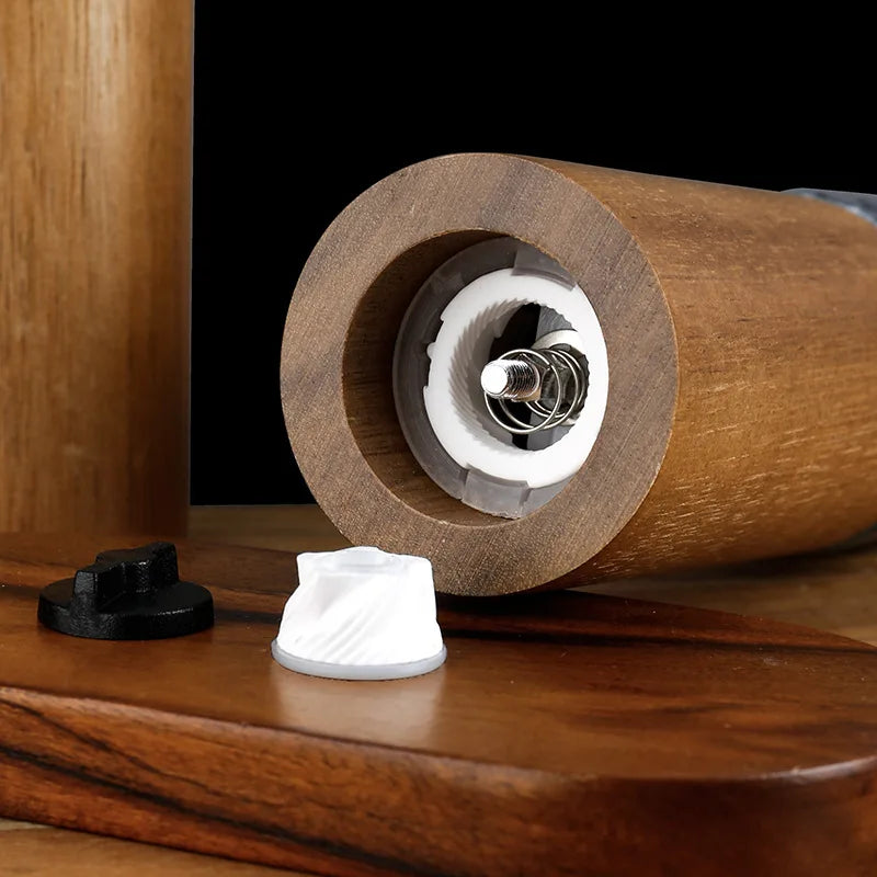 The bottom of a spice grinder with its ceramic grinding mechanism visible.