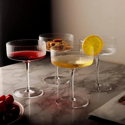 Set of cocktail glasses with drinks and garnishes on a marble surface
