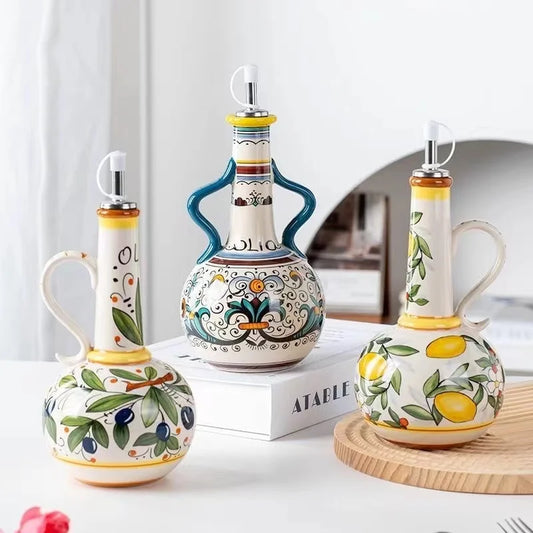 Set of three decorative ceramic bottles with artistic designs on a white surface.