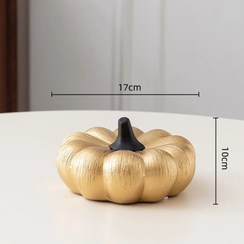 A golden pumpkin with a black stem is shown with its dimensions: 17 cm wide and 10 cm high.
