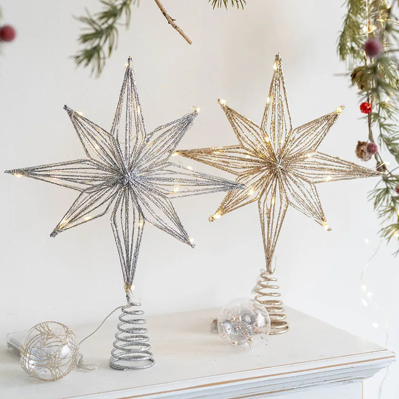 Lit glitter wire Christmas tree toppers, one silver, one gold.