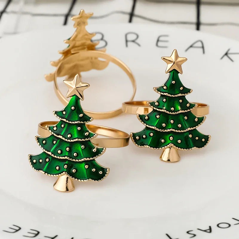 Green Christmas tree-shaped rings with gold accents on a white background