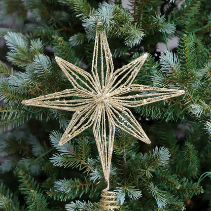 Gold glitter wire star tree topper on a Christmas tree.