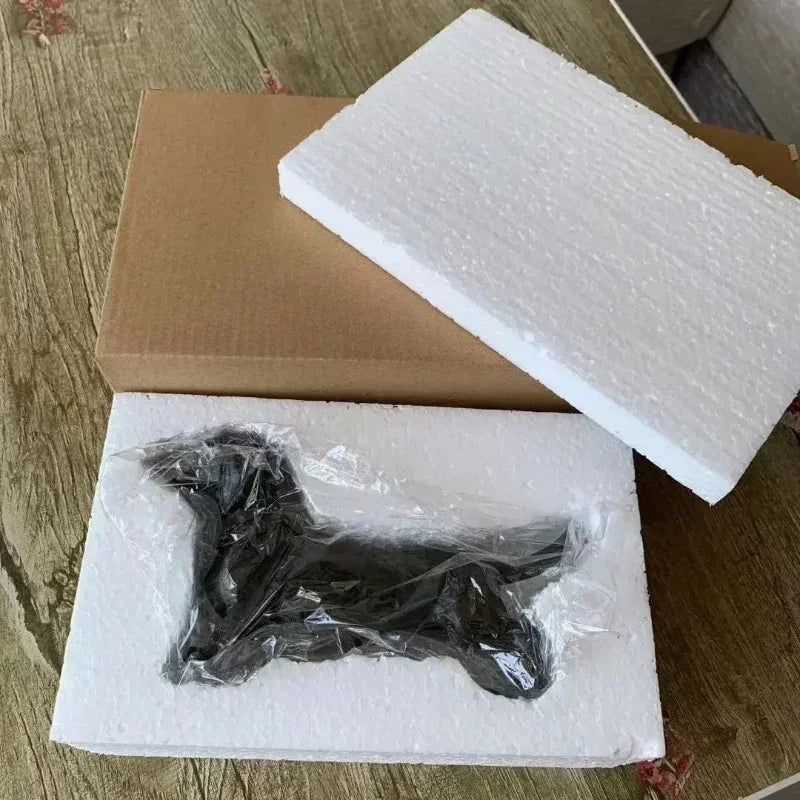 Dachshund figurine in styrofoam packaging.