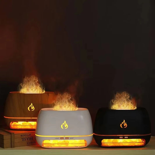 Three flame-effect humidifiers in wood, white, and black finishes, emitting a warm mist resembling real fire. The Himalayan salt stones at the base create a soft glow, enhancing the ambient lighting in a dark setting.