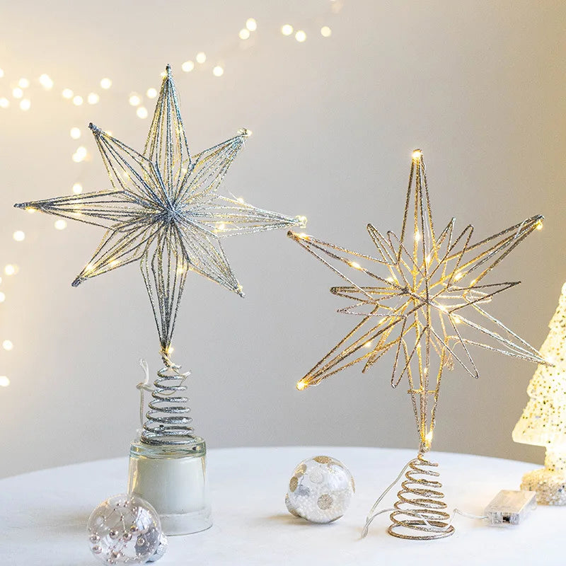 Two light-up, glitter wire star Christmas tree toppers, one silver, one gold.
