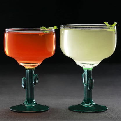 Two colorful cocktails in cactus-shaped glasses on a dark background