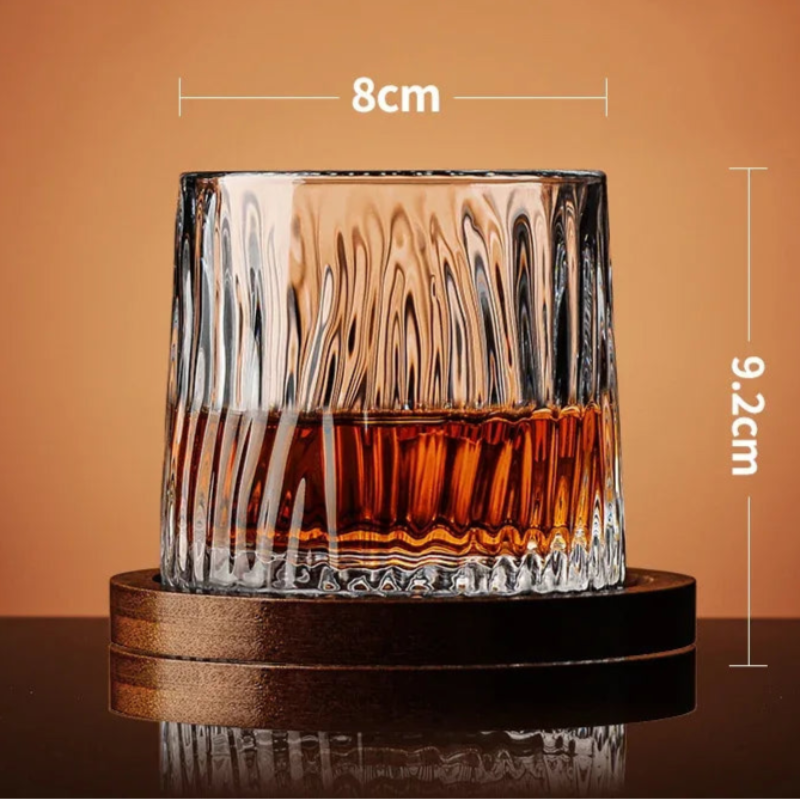 A glass with a ridged, wavy texture filled with amber liquid sits on a wooden coaster, with its dimensions noted.