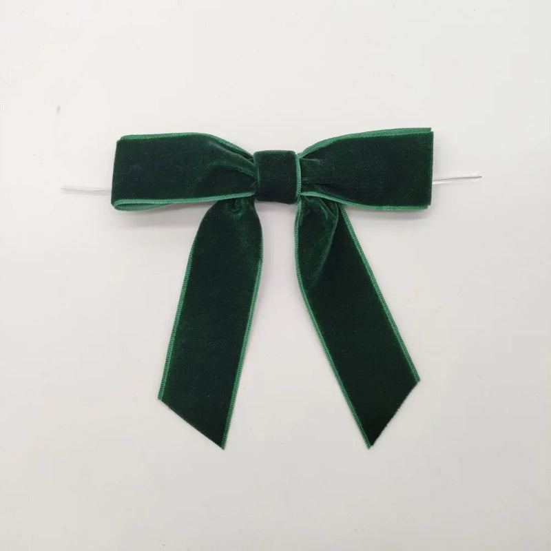 Green velvet bow on a white background