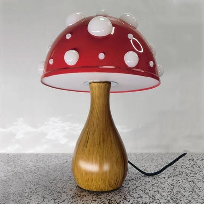 A mushroom-shaped lamp with a red cap and white spots, on a patterned surface.
