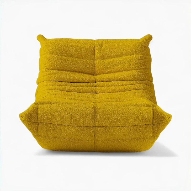 Front view of a yellow bouclé modern lounge chair.