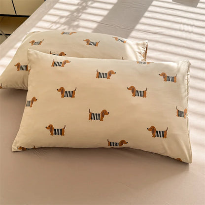 Two pillows with dachshund pattern on a beige surface