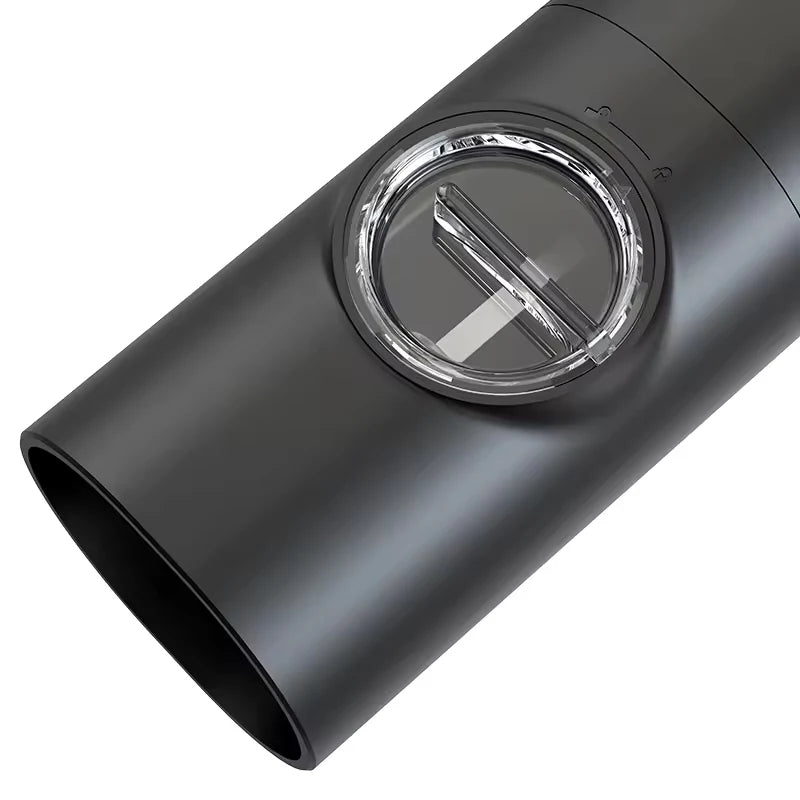 A close-up of a black automatic spice grinder, showing the clear window and the adjustable grinding mechanism.