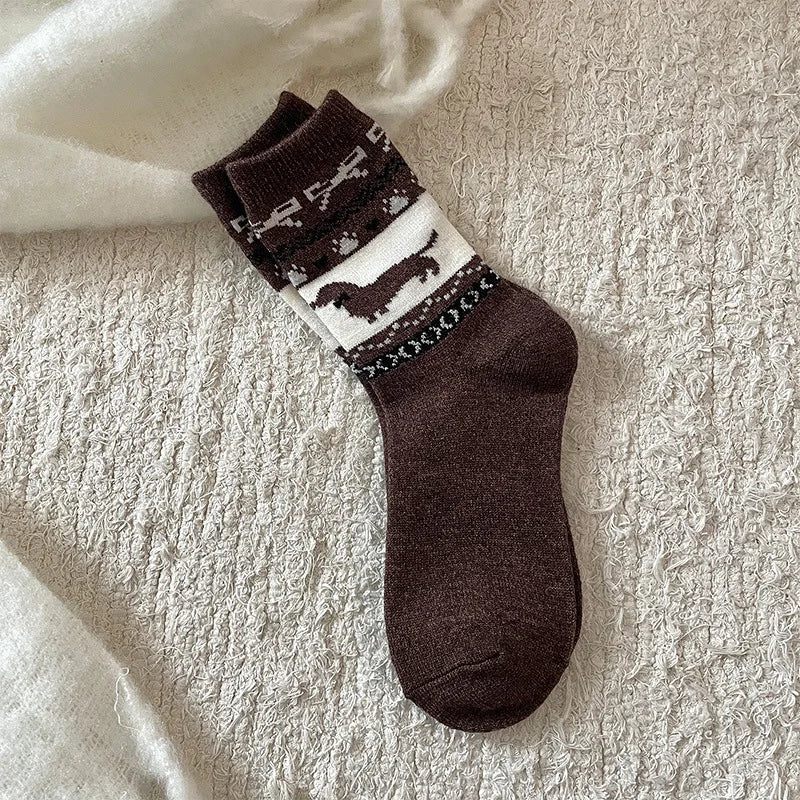 Brown sock with black and white pattern on a textured beige surface