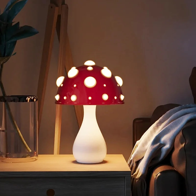 A mushroom-shaped lamp with a red cap and white spots, on a bedside table.
