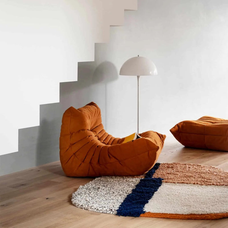 Brown chair and ottoman in a minimalist room.