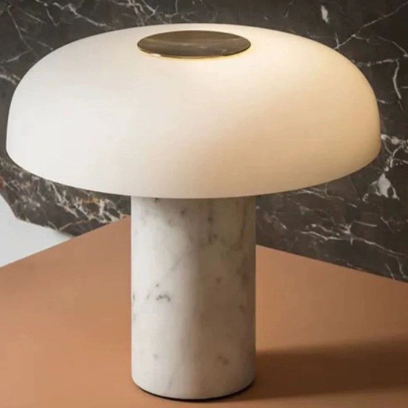 Mushroom-shaped table lamp with marble base on a brown surface