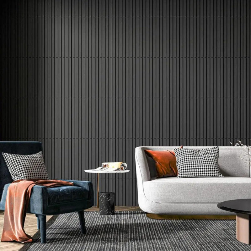 Modern living room with a gray sofa, blue armchair, and black wall.